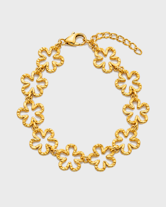 Pulseira LIRIA dourada com dez flores vazadas, apresentada em oval com fecho e corrente extensora orientados para cima