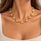 Colar SOLEA dourado com sóis usado ao pescoço por modelo, enquadramento das clavículas sem mostrar o rosto